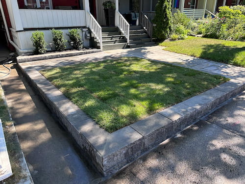 Raised rectangular lawn with stone wall by Berner Landscape, landscaping contractors in Scarborough.