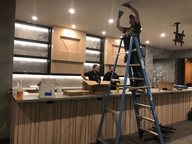 An electrician from Leite Electric Ltd. working on a commercial space installation, showcasing skilled electricians in Sherwood Park.