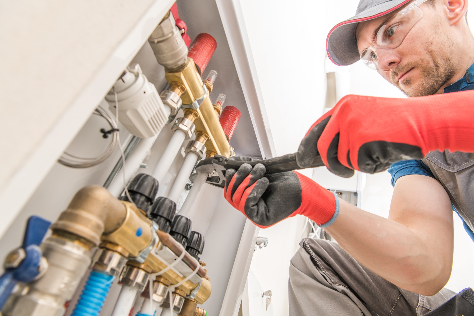 Experienced HVAC technician servicing a residential unit in Hampton